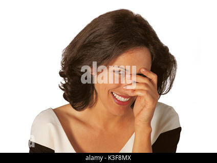 Laughing woman mischievously, her face is behind her hand Stock Photo