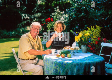 Senior citizen's couple at the coffee drinking in the garden Stock Photo