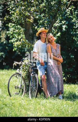 Couple in love leans in a tree Stock Photo