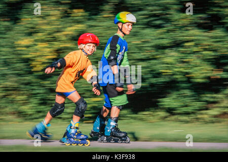 Boy and girl close the inline skating Stock Photo