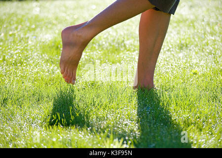 Barefooted walking on a meadow with  morning rope Stock Photo