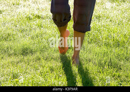 Barefooted walking on a meadow with  morning rope Stock Photo