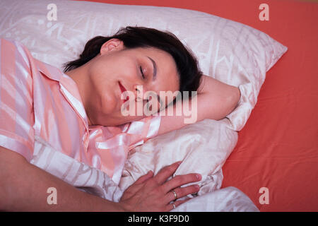 Sleeping woman in the bed Stock Photo
