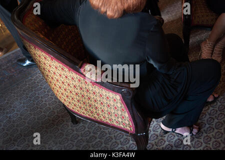 High Angle Rear View of Senior Woman Sitting in Chair Stock Photo