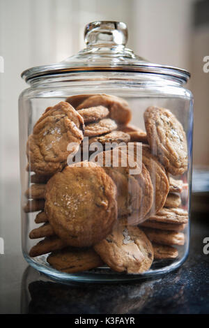 Lid-Covered Cookie Jar Filled with Chocolate Chip Cookies Stock Photo