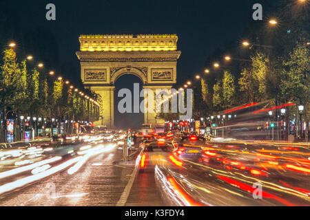 Traffic at night in front of the triumphal arch in Paris Stock Photo