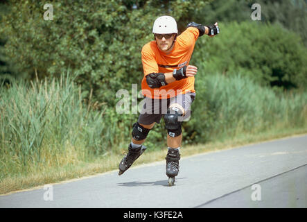 Young man at the inline skating Stock Photo