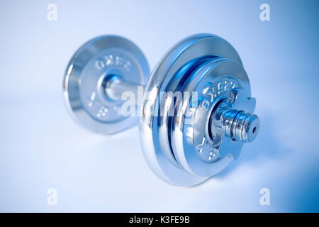 Exercise with dumb-bells Stock Photo