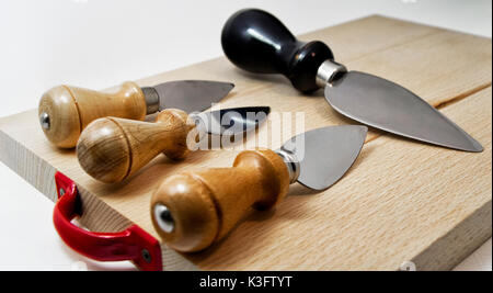 set of knives for italian typical parmiggiano reggiano cheese. for food concept Stock Photo