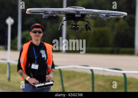 A drone pilot at the 'Dronemasters Dronathon' steers his multicopter drone in Berlin, Germany, 3 September 2017. Photo: Maurizio Gambarini/dpa Stock Photo