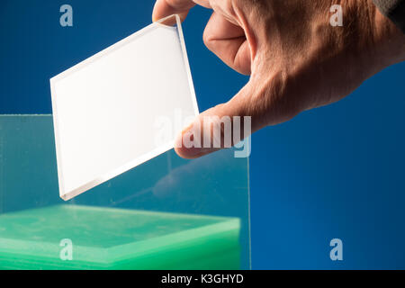 Bulletproof glass in the laboratory of optics. Checking the optical properties of tempered glass Stock Photo
