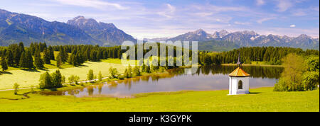 Panorama scenery in Bavaria close view over the Hegratsrieder pond on the mountain range of the Allgäuer alps Stock Photo