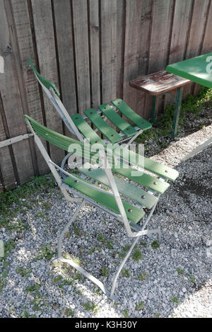 Two beer garden chairs in front of wooden facade Stock Photo