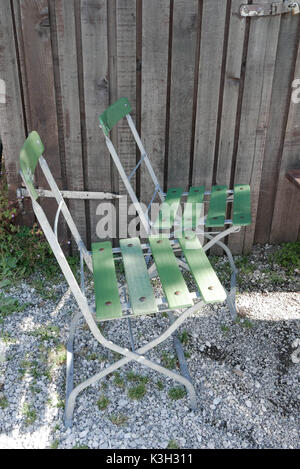 Two beer garden chairs in front of wooden facade Stock Photo