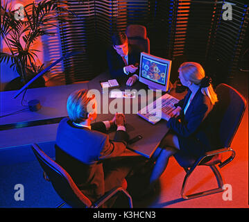 High viewpoint of three business executives in office. Stock Photo