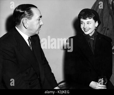 AUDREY HEPBURN [1929 - 1993] Belgian-born International Actress with ROBERT CLARK, the Executive Director of Production, Associated British Picture Corporation. Hepburn was contracted as one ABPC's artistes. (early 1950s)  AUDREY HEPBURN Stock Photo