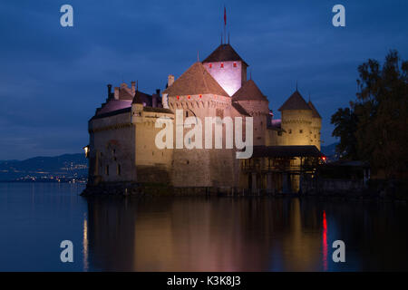 12th century Chillon castle at dusk along Lake Geneva,  Veytaux, Montreux Switzerland Stock Photo