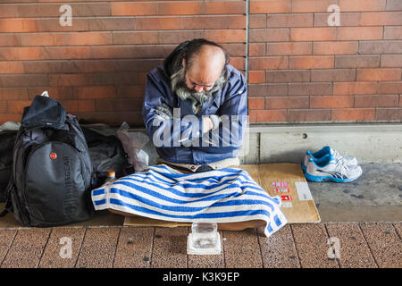 Japan, Hoshu, Tokyo, Akihabara, Homeless Man Begging Stock Photo