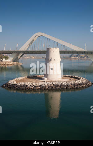 UAE, Abu Dhabi, Sheikh Zayed Bridge, designed by Zaha Hadid and old Al Maqta Fort watchtower Stock Photo