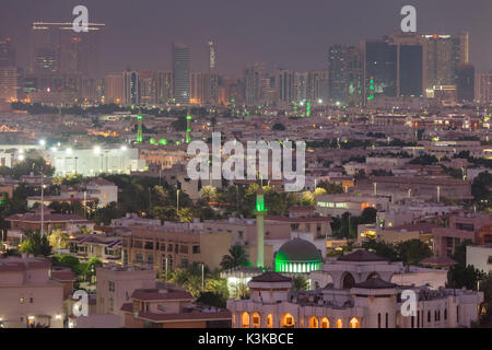 UAE, Abu Dhabi, elevated skyline view with mosque over Baynunah Street, dusk Stock Photo