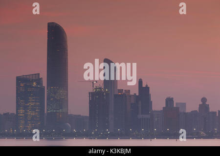 UAE, Abu Dhabi, city skyline along the Corniche, dawn Stock Photo