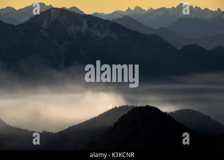 Major operation of the fire brigade after forest fire in the 1/1/2016 caused by two mountaineers, Helicopter of the Tirol mountain rescue service, The smoke forms a nice nebulous mood. Stock Photo