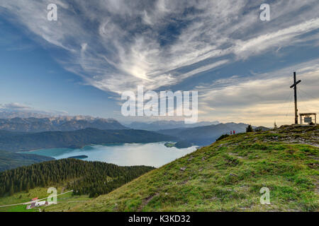 View from the Jochberg on the Walchensee. Two men look at the foot of the summit to the close alp. Stock Photo