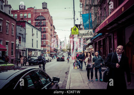 Typical Streetview with traffic and brick houses, fire stairs, pedestrians in Little Italy, Manhatten, New York, USA Stock Photo