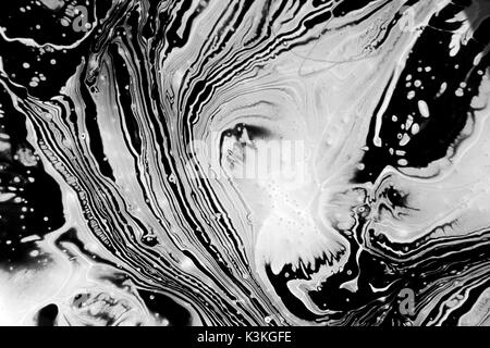 Abstract black and white artwork as a result of mixing paint Stock