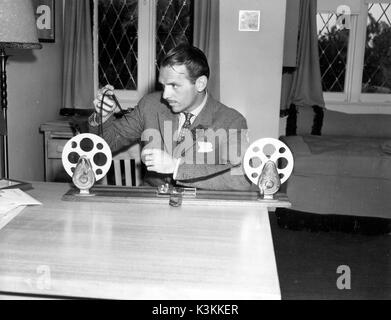 Film actor, DOUGLAS FAIRBANKS JR, at home looking at some 16mm home movies Stock Photo