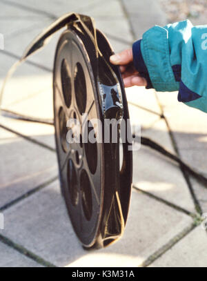 A metal spool with 2,000 feet of 35mm Technicolor safety film printed by the dye-transfer system. The extreme warping of the film indicatess that it is badly affected by a deterioration commonly known as 'the  vinegar syndrome'  This can make the film, as in this case, unshowable because of the film's buckled surface. Stock Photo