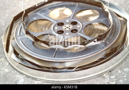 A metal spool with 2,000 feet of 35mm Technicolor safety film printed by the dye-transfer system. The extreme warping of the film indicatess that it is badly affected by a deterioration commonly known as 'the  vinegar syndrome'  This can make the film, as in this case, unshowable because of the film's buckled surface. Stock Photo