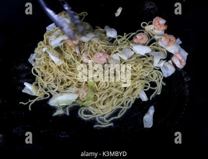 Shrimp Yakisoba Stir Fry made with grilled shrimp with stir-fry noodles and cabbage cooking on a grill Stock Photo