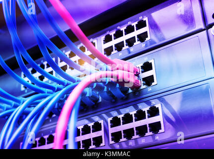 Network cables in switch and firewall in cloud computing data center server rack Stock Photo