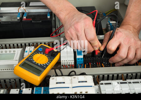 Close-up Of A Male Electrician Checking Fuse With Multimeter Stock Photo