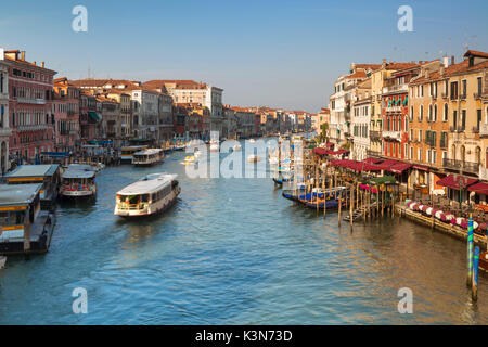 Venice, Italy. View over the Grand Canal with gondolas and vaporetti as seen from the Rialto Bridge in the sun light.