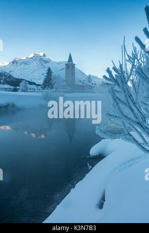 Foggy sunrise in winter. Sils Maria, Sils im Engadin, Graubunden, Switzerland. Stock Photo
