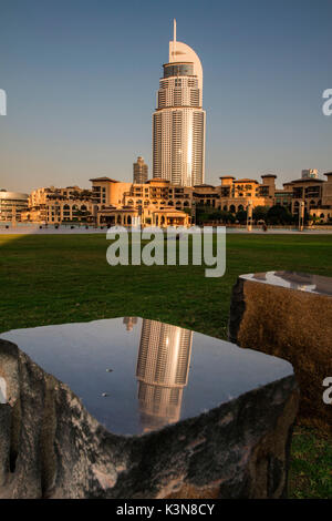 The skyscraper of Hotel Address Downtown Dubai is reflected on a polished rock. Dubai, United Emirates Arab Stock Photo