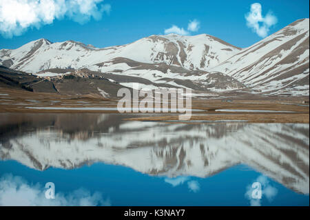 Reflections on Piano Grande in a winter day, Piano Grande di Castelluccio di Norcia, Monti Sibillini NP, Italy Stock Photo