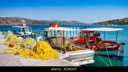 Fishing boats with nets at the pier in the village of Plaka in Crete, Greece Stock Photo