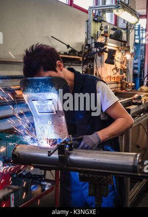 Use of wire welding machine in a metalwork factory. Stock Photo