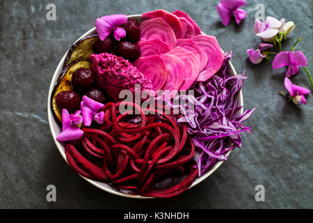 Vegan bowl with raw and cooked beetroot , red cabbage, aubergine Stock Photo
