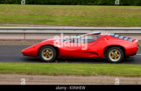 A red 1967-68 vintage Ford Lotus VW-Nova-kit-car travelling along the Kingsway West dual carriageway in Dundee, UK Stock Photo