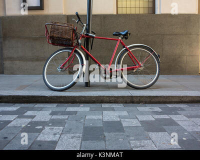 A red vintage bicycle  with a basket Stock Photo