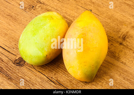 Sweet mango fruit over the wooden background Stock Photo