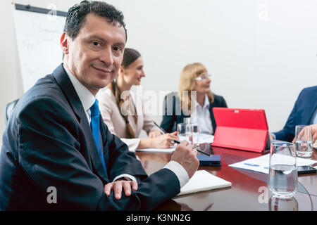 Portrait of a Hispanic middle-aged business man smiling and look Stock Photo