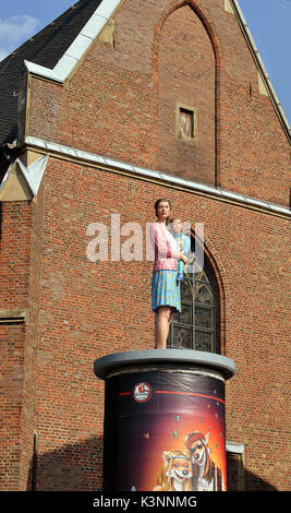 'Säulenheiligen' (Stylites) is an art project of Christoph Pöggeler in Düsseldorf placing life-size polyester figures of people living and working in  Stock Photo