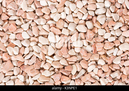 Small beige color round pebbles gravel background texture. Stock Photo