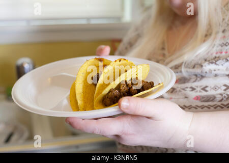 Two hard taco shells partially filled with beef Stock Photo
