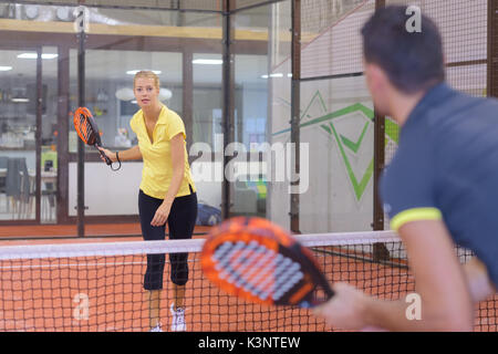 playing padel tennis indoor court Stock Photo
